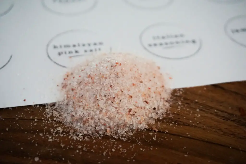 Picture shows pile of Himalayan pink salt with corresponding spice label.